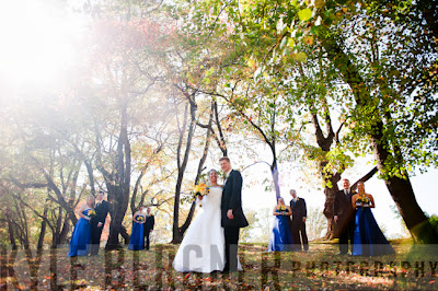 Bridal party in the woods with sun coming through the trees