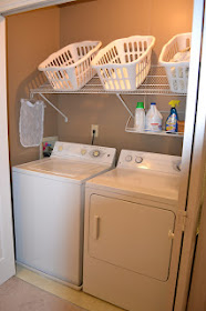 Tilted shelf in laundry room for baskets :: OrganizingMadeFun.com