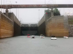 Small boats scurrying into the lock to return to GTB.  The rain is falling.  Hooray!