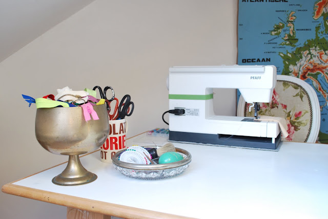 sewing machine, bowl with zippers, sciccors