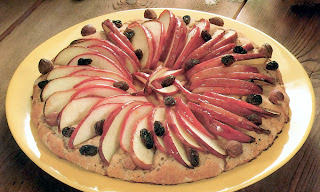 Hot Apple Pizza: Classic vegetarian dessert pizza topped with sliced apples, raisins and hazelnuts