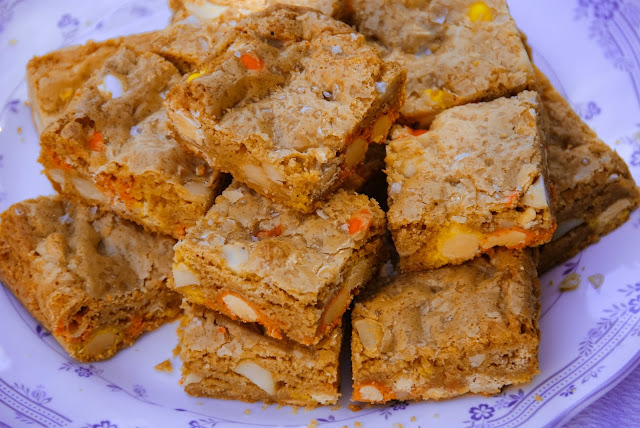 a pile of candy corn M&M, roasted macadamia nut, and sea salt blondies on a plate