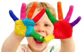 kid with paint all over his hands
