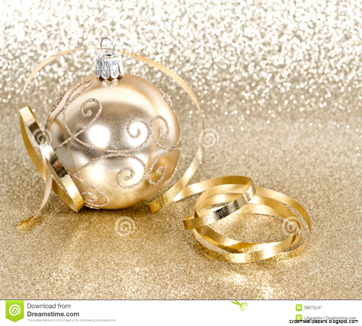 Golden christmas ball with streamer over golden shiny background Golden christmas ball with streamer over golden shiny background