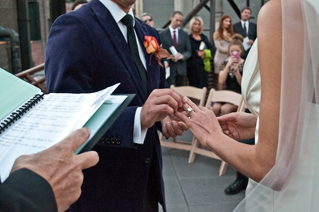 The ring exchange on a rooftop wedding.