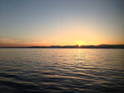 the sun sets on Seattle