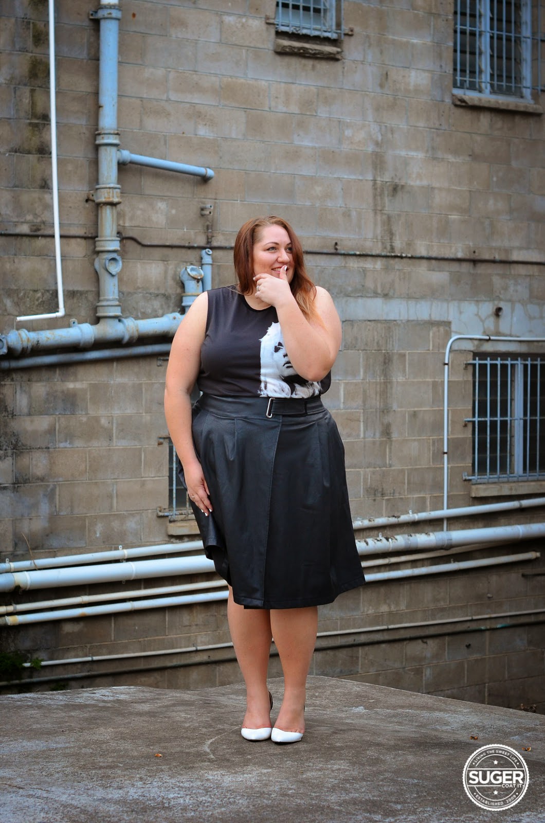 Melissa from Suger Coat It blog wearing black sleeveless short dress, white shoes