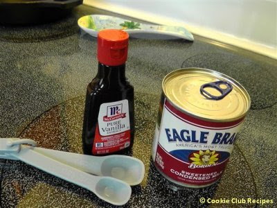 vanilla extract and condensed milk with measuring spoons