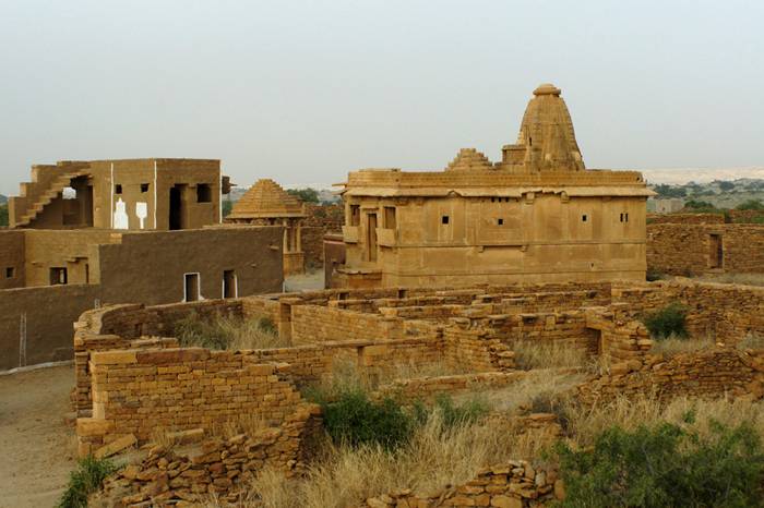 Kuldhara village near Jaisalmer has a very unique history! It is said that the residents of 84 neighboring villages including Kuldhara vacated the villages overnight around 170 years back!! No one is sure where they have gone, but they are believed to have migrated to a place somewhere near Jodhpur. The residents were Paliwal Brahmans — said to be very intelligent, and residing there for about 500 years. So what made them do such an act? Stories say that the ruler of these villages pounded the Paliwals with heavy taxes and treated them very inhumanly; the ruler was unethical and forceful to them. They had no alternative, but to vacate all the 84 villages overnight and just disappear from the vision and reach of the ruler.  When the Paliwals left the villages, they left a curse that nobody can inhabit the villages ever. Residents of Jaisalmer say that there have been some attempts by some families to stay there, but they did not succeed.