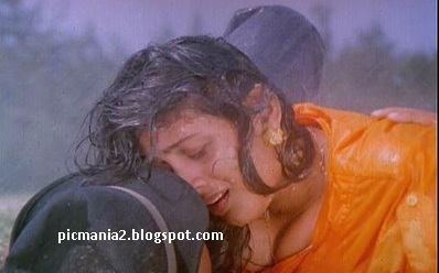 Suchitra boobs popping out rare cleavage show in wet image gallery