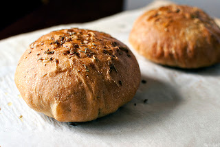 2 loaves of rosemary bread on parchment paper