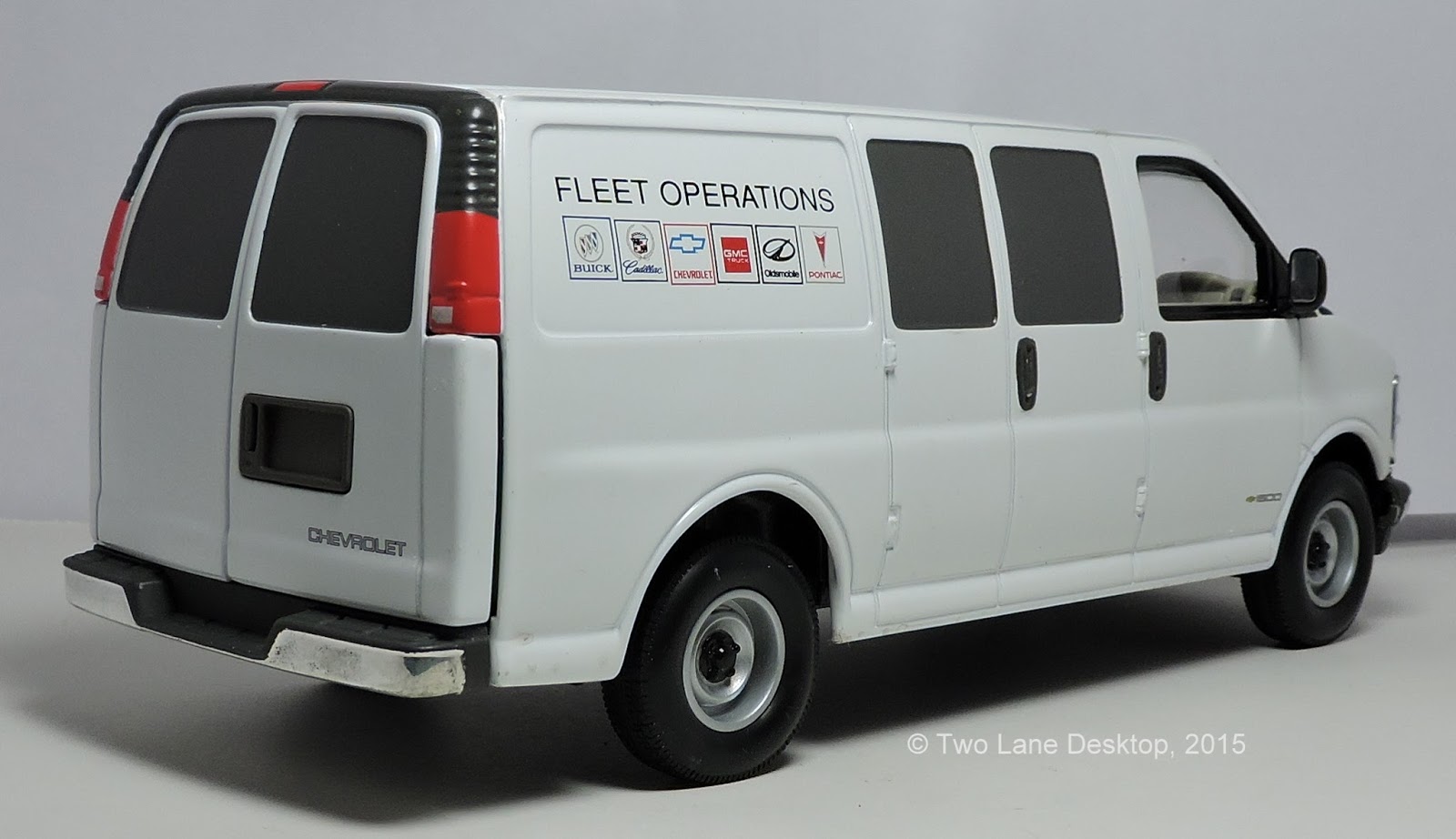 Two Lane Desktop 124 GMC Savana work van, Brookfield Chevy Express van, and Johnny Lightning