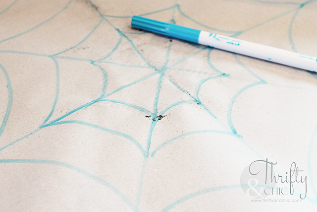 Glittery spider web placement using hot glue!