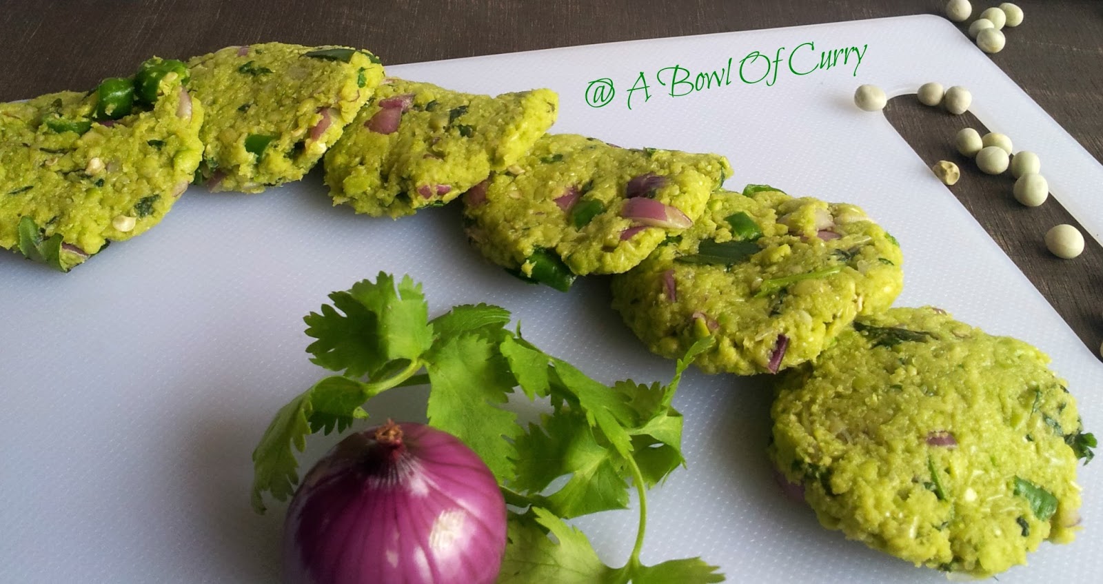 A Bowl Of Curry Green Peas Vada