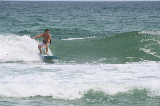 Joey longboard surfing at Pensacola Beach on Sunday May 13, 2012