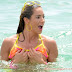 Jennifer Nicole Lee just manages to cover her ample assets as her bikini slips off during ocean dip