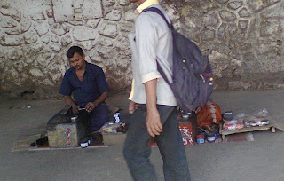 Shoe shine man polishing shoes at railway station, andheri bandra cst central railway