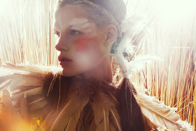 woman in feather headpiece, tribal makeup, festival beauty photography