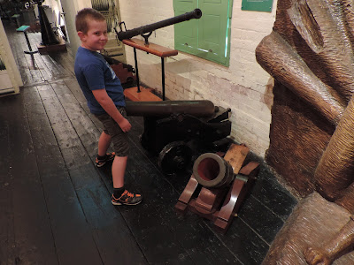 boy with his penis in a naval cannon