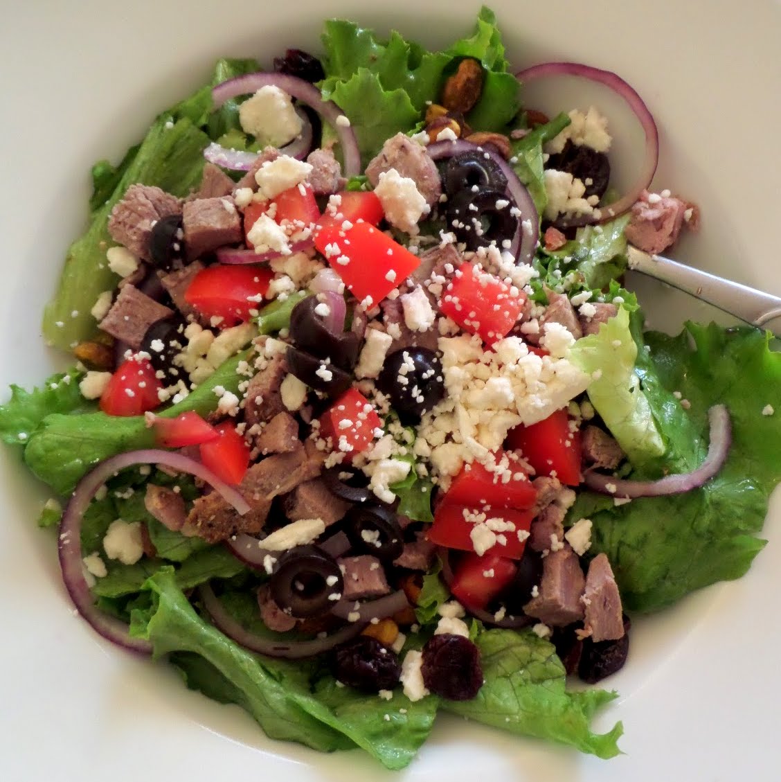 Lamb Salad:  A green salad topped with left over Herb Roasted Leg of Lamb, olives, tomatoes, and feta.