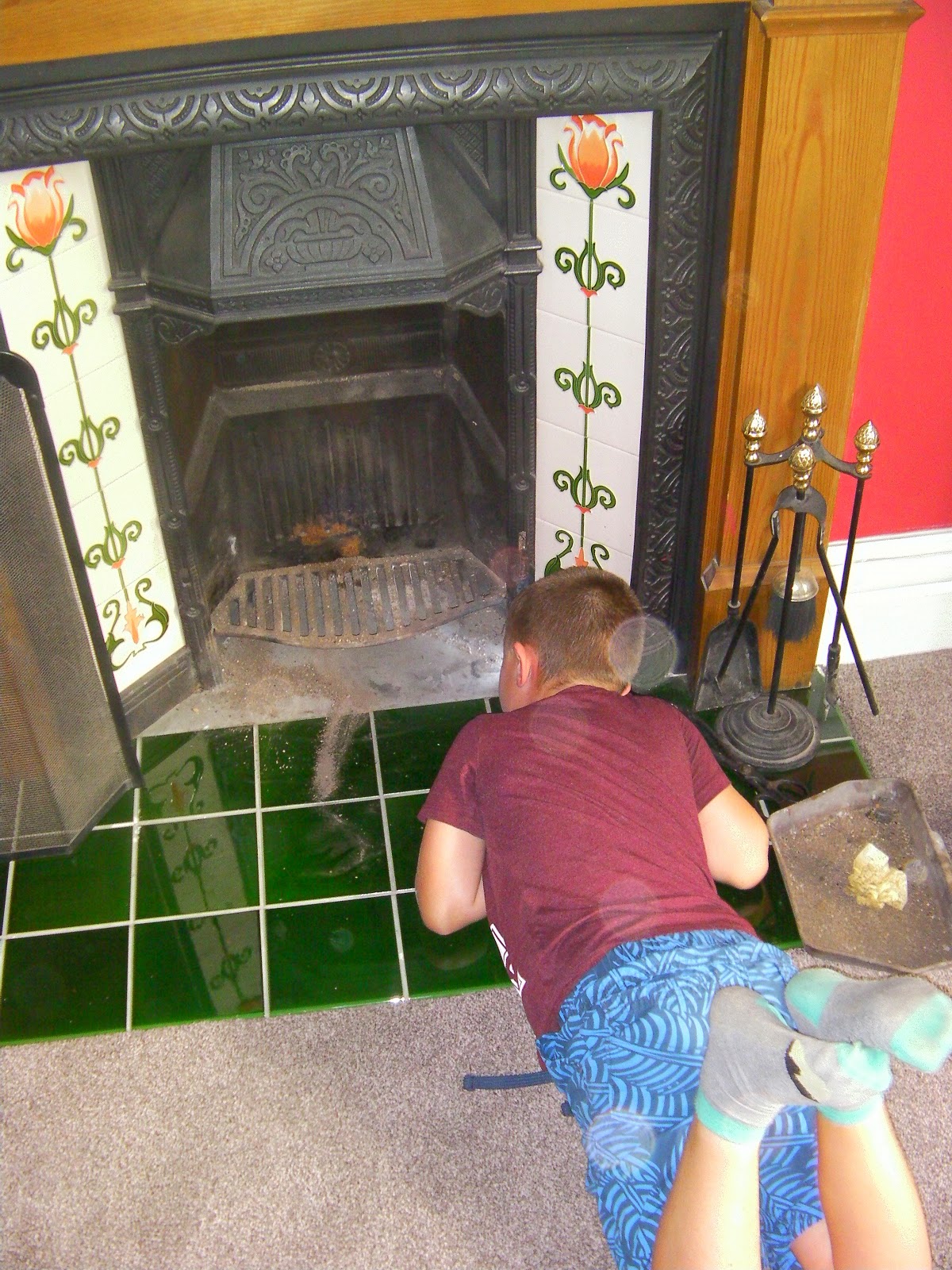 boy hunting mice behind the fireplace