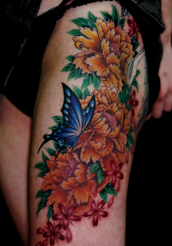 Above This Japanese tattoo design boasts a butterfly in a garden of flowers