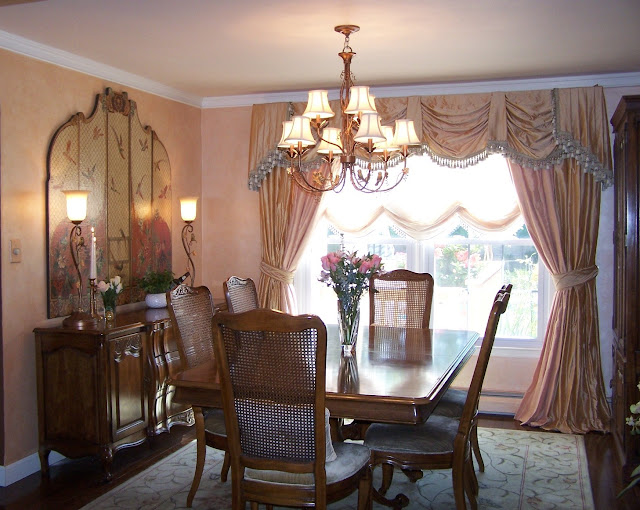 A nice dining room with a pale glazed wall and pale pink window treatments