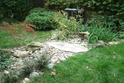 Dry stream bed rain garden hiding disconnected downspout by garden muses: a Toronto gardening blog