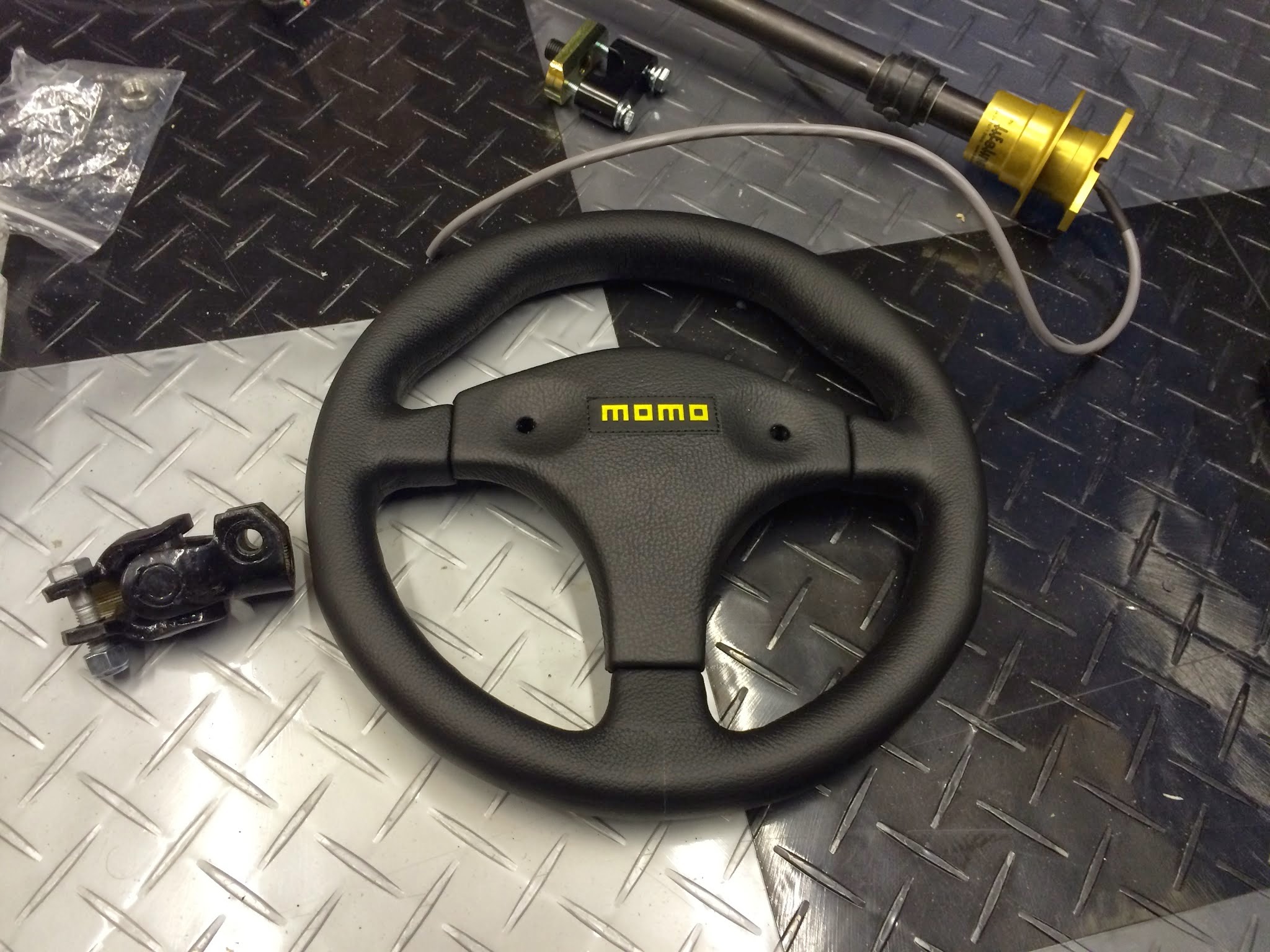 Steering wheel, UJ, upper column with quick release boss and clamp plate.