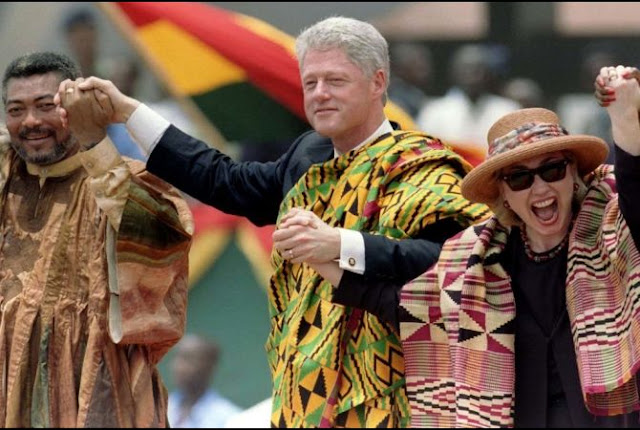 Former U.S. President Bill Clinton (center) and his wife Hillary Rodham Clinton sport kente cloth on their 1998 visit to Ghana. They are standing by Ghana's former president Jerry Rawlings (L) at Accra's Independence Square. (Win McNamee/Reuters)