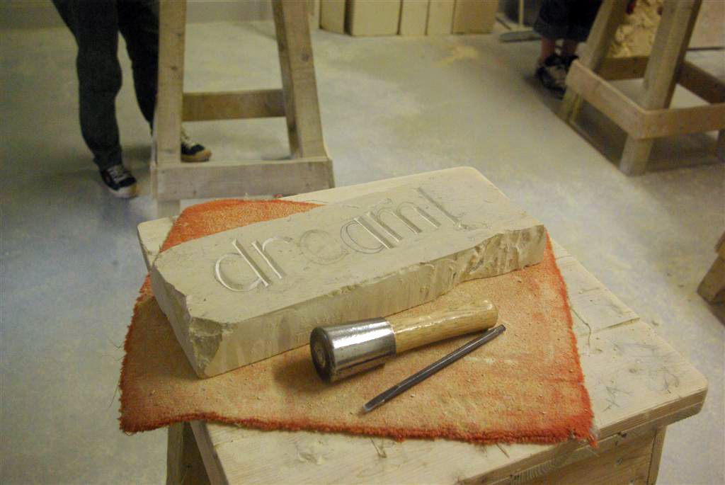 A Village Life Learning Stone Carving (lettering)