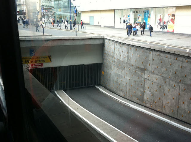 a tunnel with people walking on the street