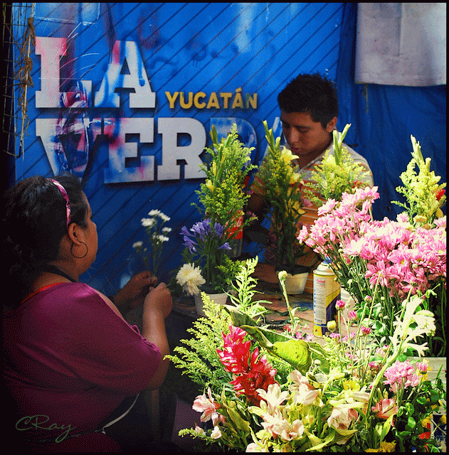 Merida Mexico woman and son flower vendors making bouquets to sell