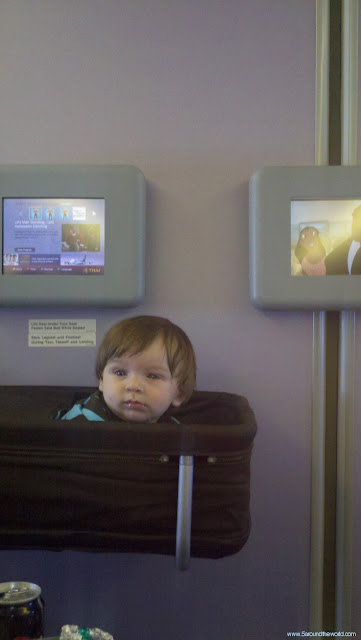 Camden in an airplane bassinet