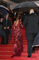 Cheryl Cole going up the stair in a marvelous red gown