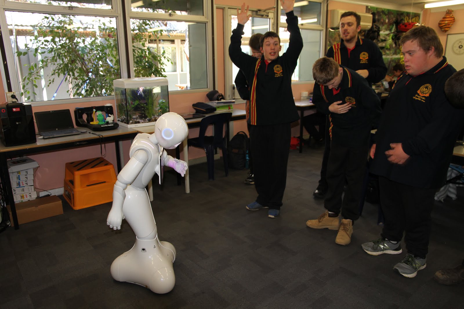 Pepper practises his dance moves with the students.