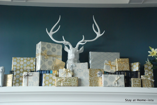 Easy holiday decor with wrapped gifts on a mantle