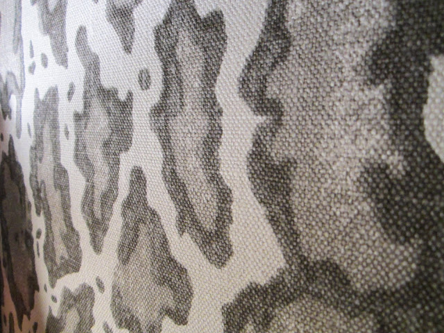 Close up of Peter Dunham's animal print Gattapardo linen fabric upholstering the walls in a sitting room in the House of Windsor