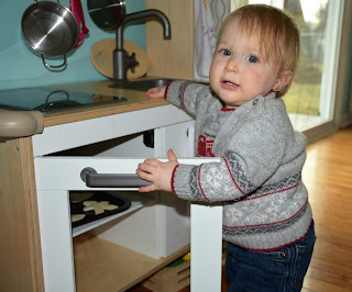 Little C baking some felt cookies in our Ikea kid's kitchen