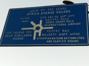Direction sign post at Dembel Square