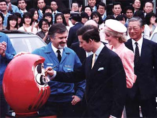 Prince Charles painting a Daruma doll eye