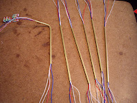 Four thin wire leads threaded through each copper tube support