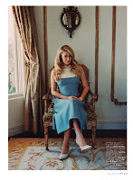 Paris Hilton in a blue dress sitting on a chair