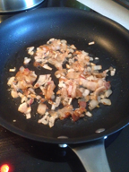 Image of bacon, shallots and garlic in the frying pan.
