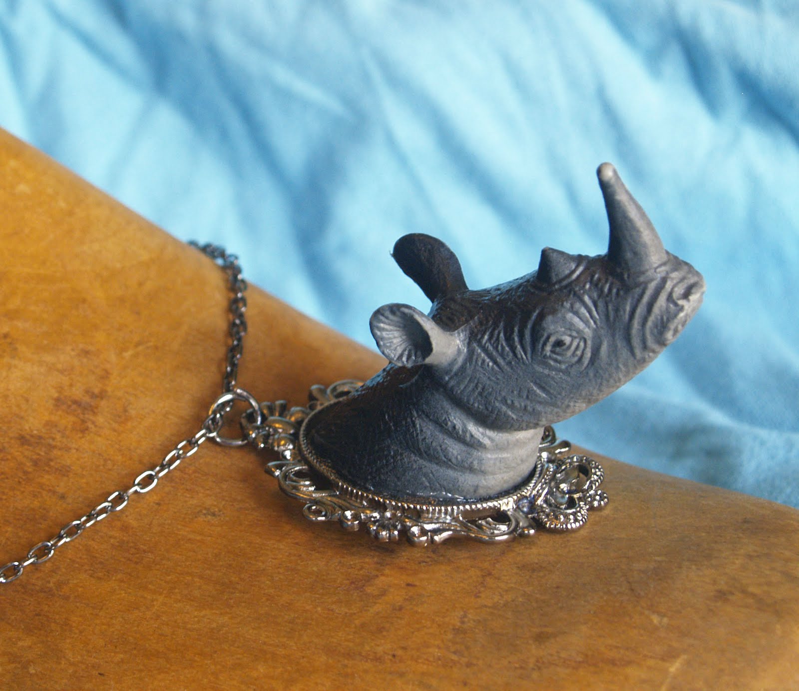 Art by Cari Rakai Animal Jewelry made from the heads of plastic beasts!