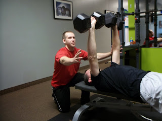 Fitness Together Brecksville personal trainer Adam Teplitz working with a strength training client