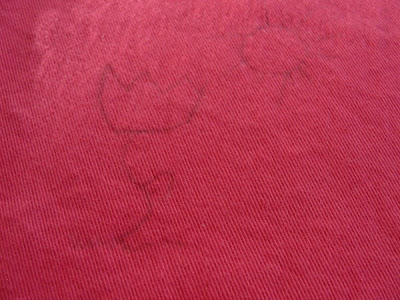child drawing on fabric