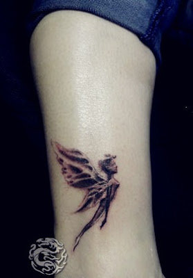 small fairy tattoo on the leg