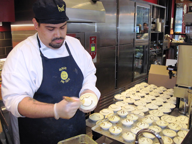 A Pie Face cook splashes on the egg wash that gives the meat pies their signature look