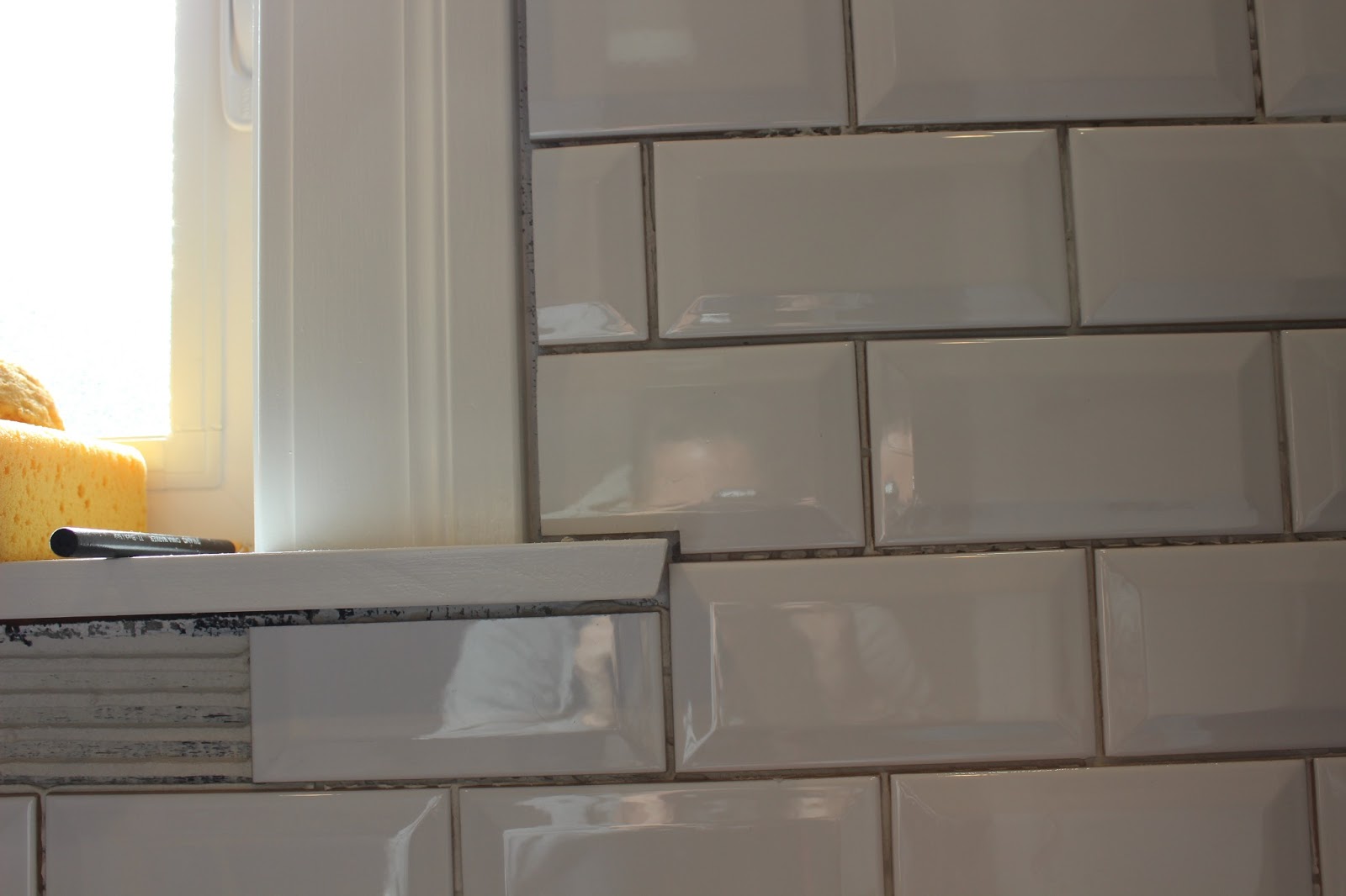 Meryl Cuts Tile. Chris Lays Tile. Repeat